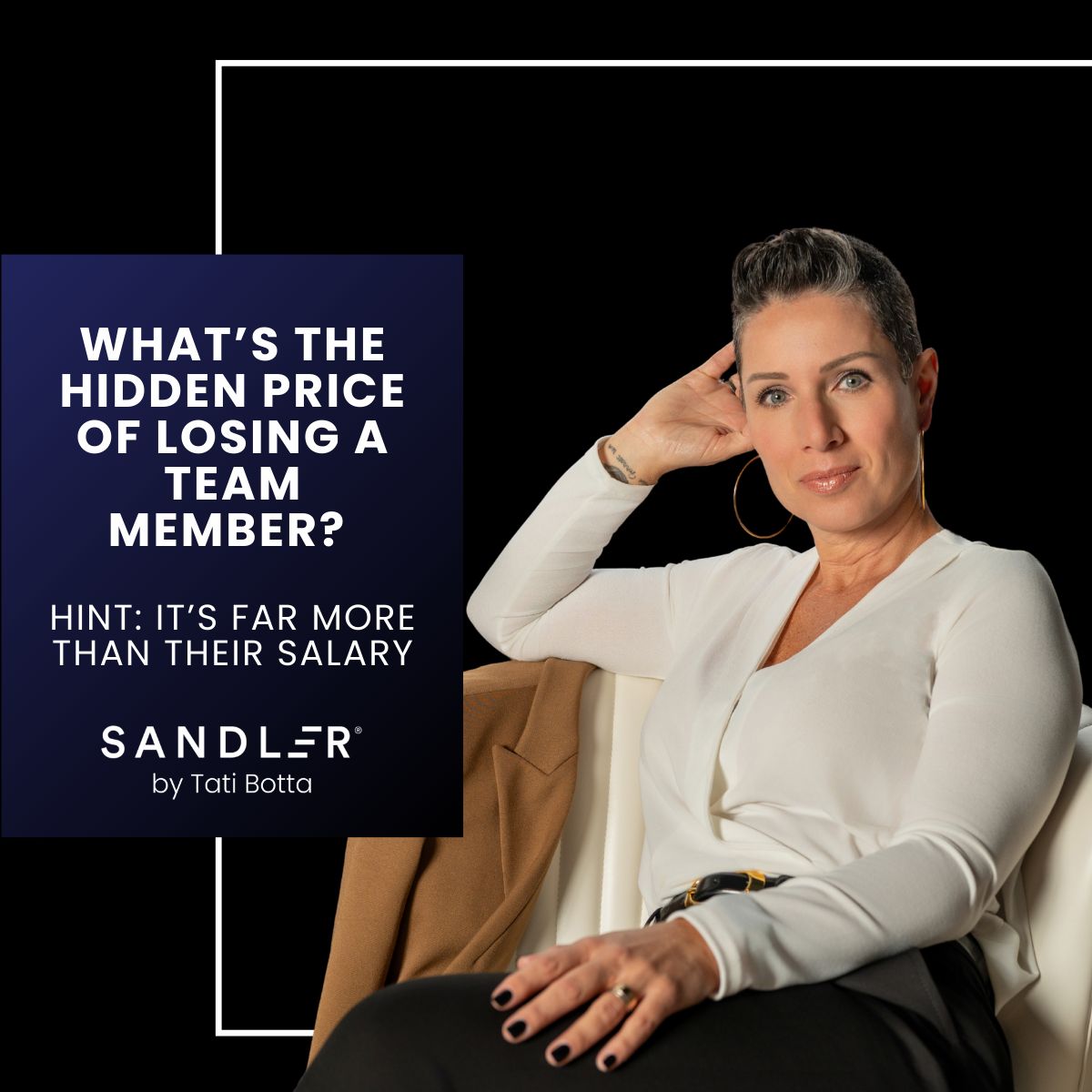 A woman sitting on a chair looking directly at the camera