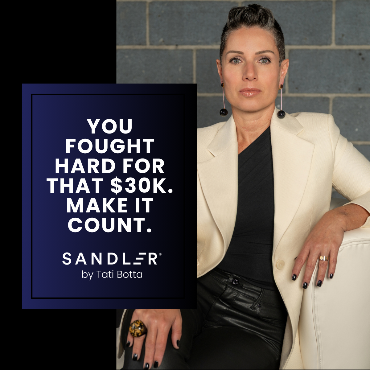 Woman sitting on a chair looking ahead without a smile.